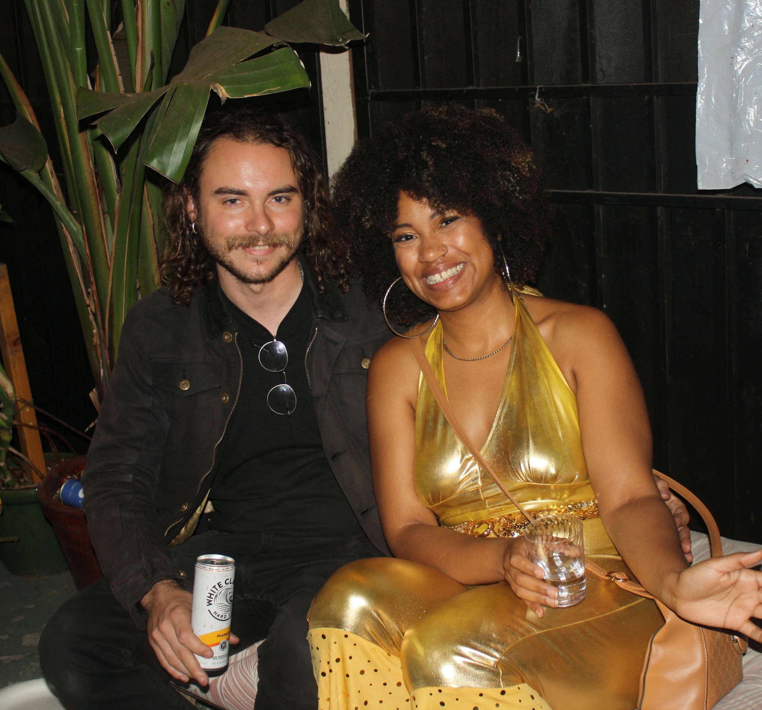 Friends posing in Goldfinger-inspired costumes